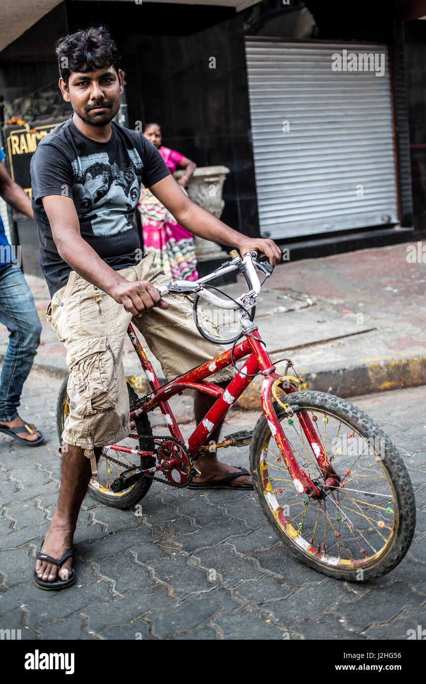 a-indian-man-sitting-on-a-bicycle-in-mumbai-J2HG56.jpg