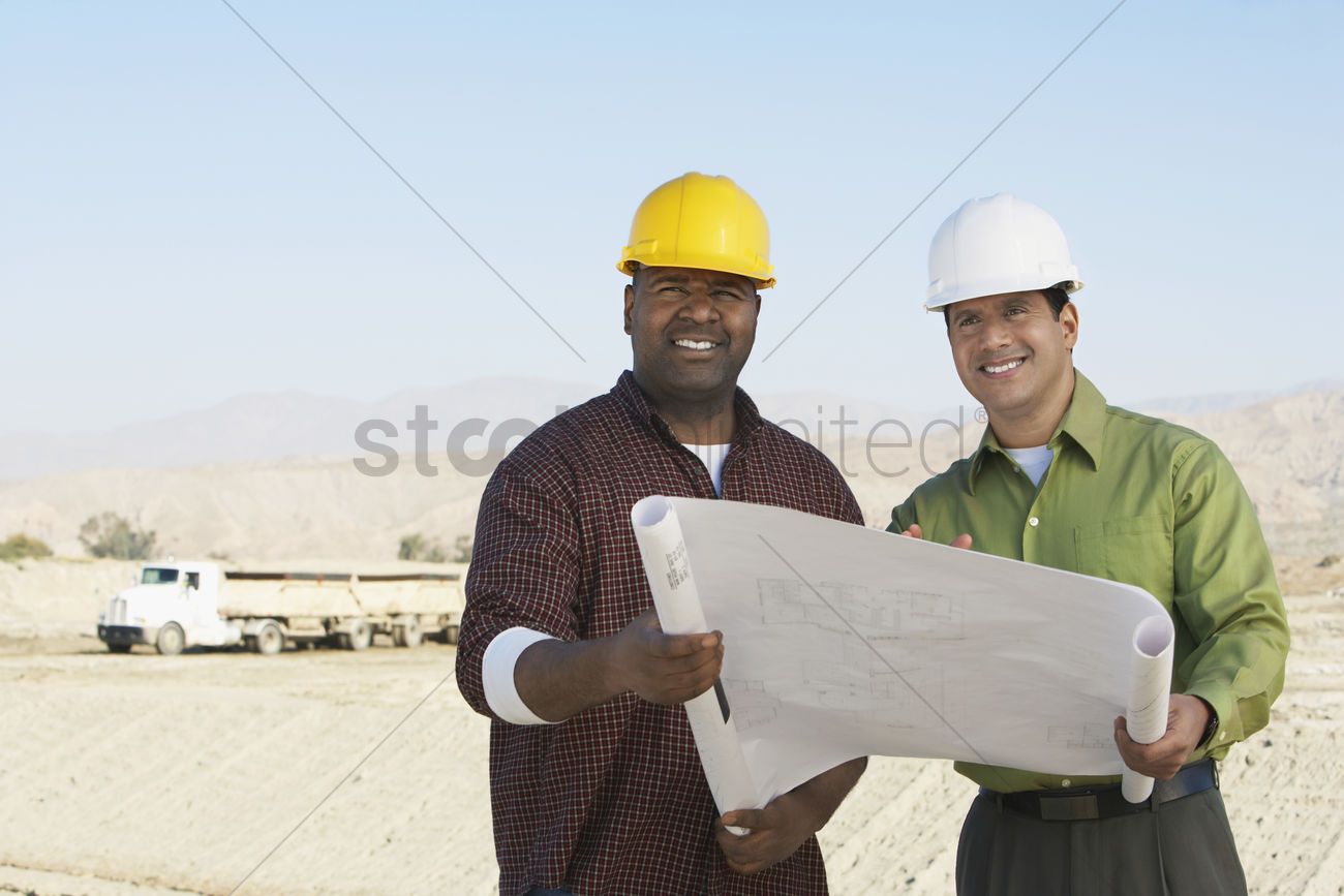 construction-workers-wearing-hard-hats-looking-at-plan-on-site_1882166.jpg