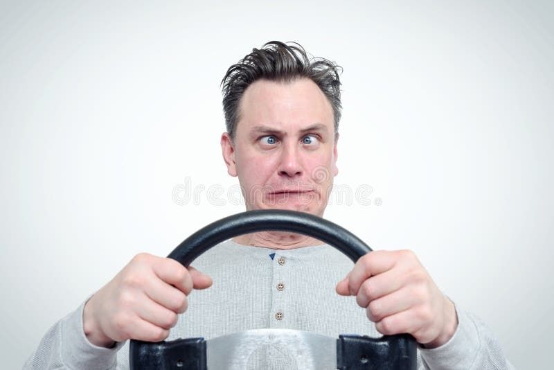 cross-eyed-funny-man-driver-steering-wheel-background-87331829.jpg