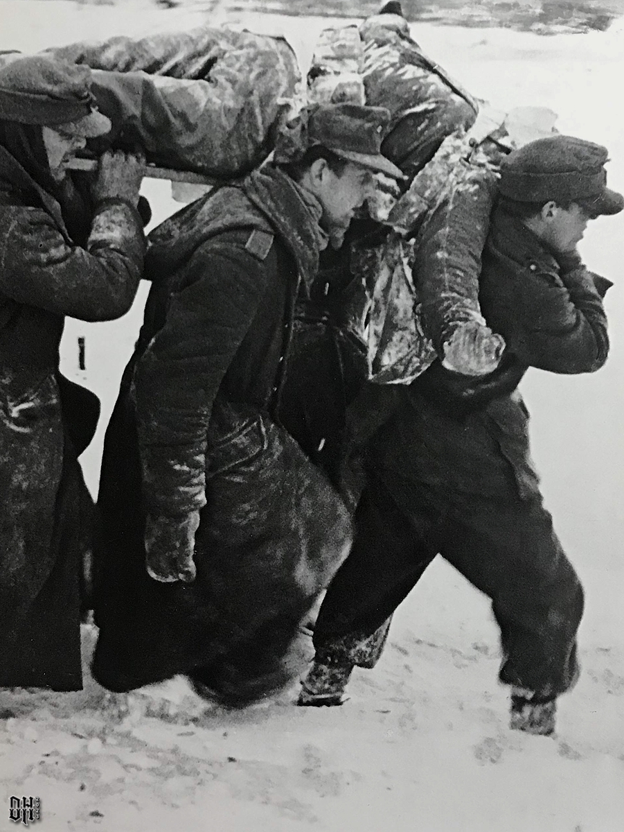 DH - Dead US Soldiers 25 - German POWs carry body of America - Battle of the Bulge.jpg