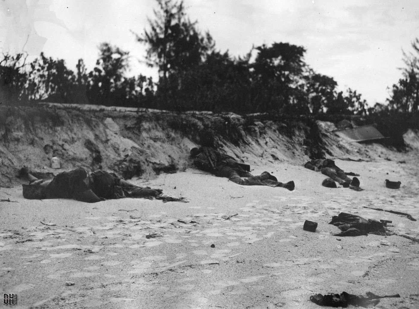 DH - Dead US Soldiers 30 - The bodies of three deceased American soldiers lie on a beach.jpg