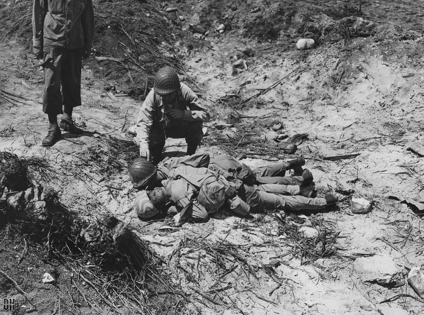 DH - Dead US Soldiers 8 - Two 7th Infantry Division soldiers look at dead bodies of other Amer...jpg
