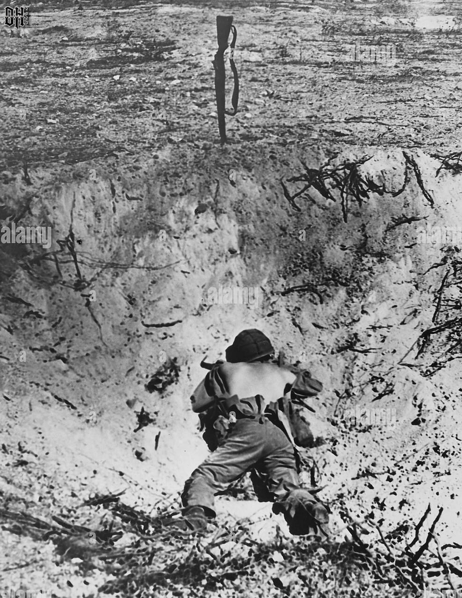 DH - Dead US Soldiers 9 - Dead US marine lies in shell hole 1944.jpg