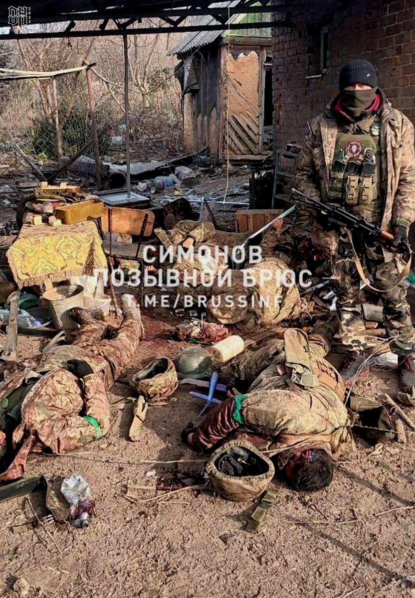 DH - Ukraine~Russia conflict - 1595 - Russian soldier with dead Ukrainian soldiers in village ...jpg