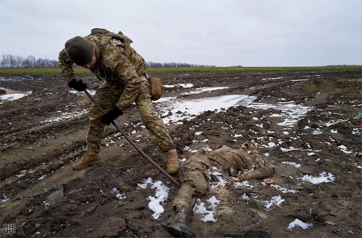 DH - Ukraine~Russia conflict - 1627 - Removal of KIA Russian soldier by Ukrainian soldier 2023.jpg