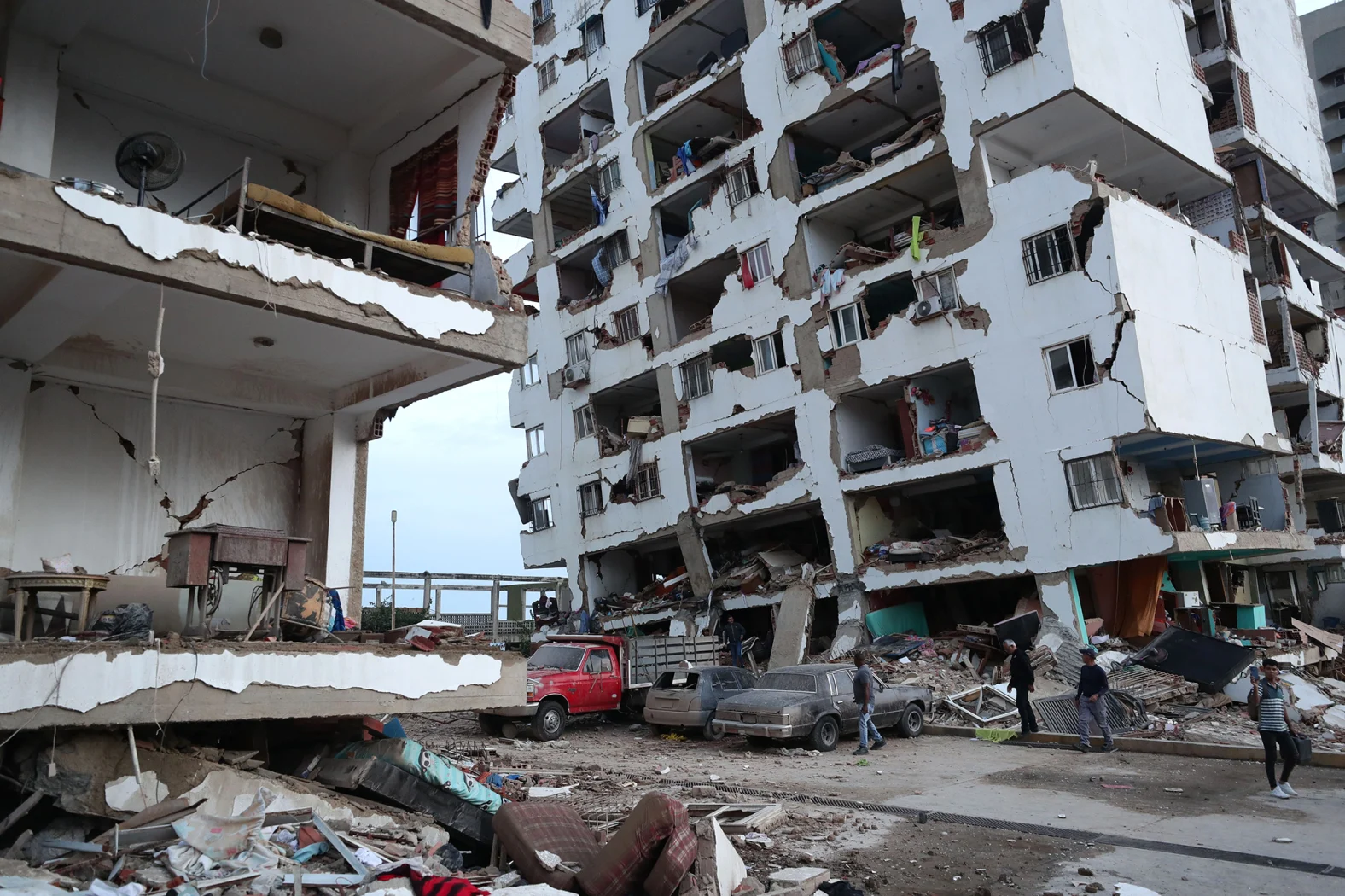 Earquake aftermath, residents walk through the rubble of apartment buildings in Catia la Mar,...webp