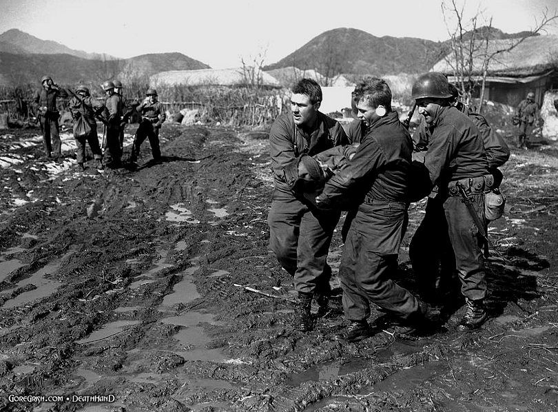 un-troops-carry-wounded-buddy-evac-heli-Korea-feb25-51.jpg