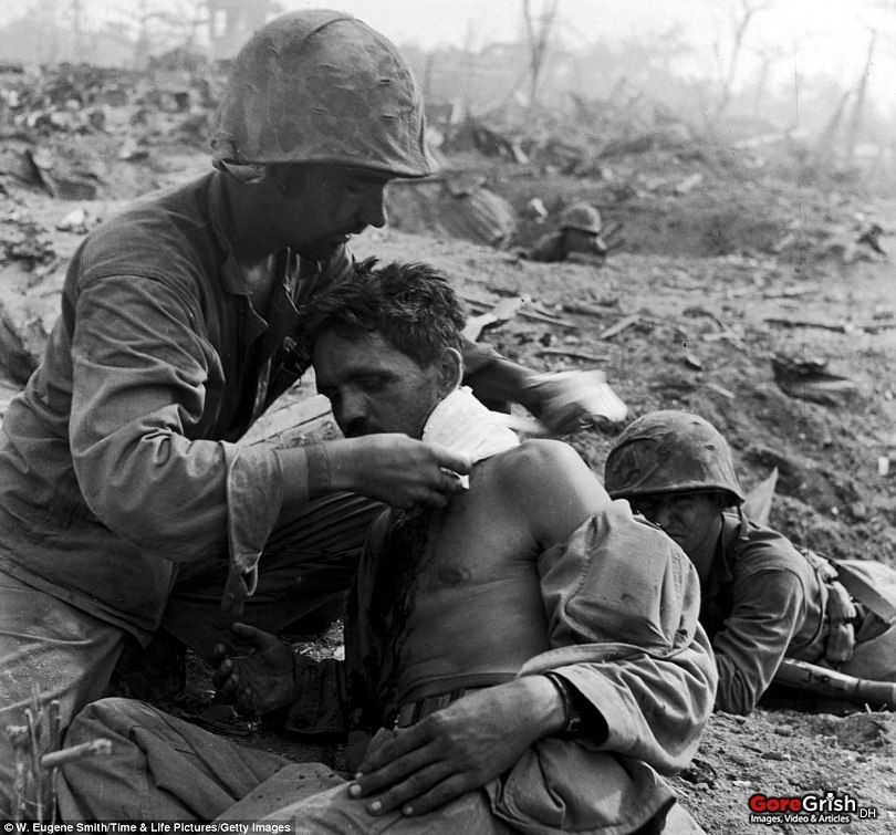 us-marine-gets-medical-aid-neck-wound-Saipan-june1944.jpg
