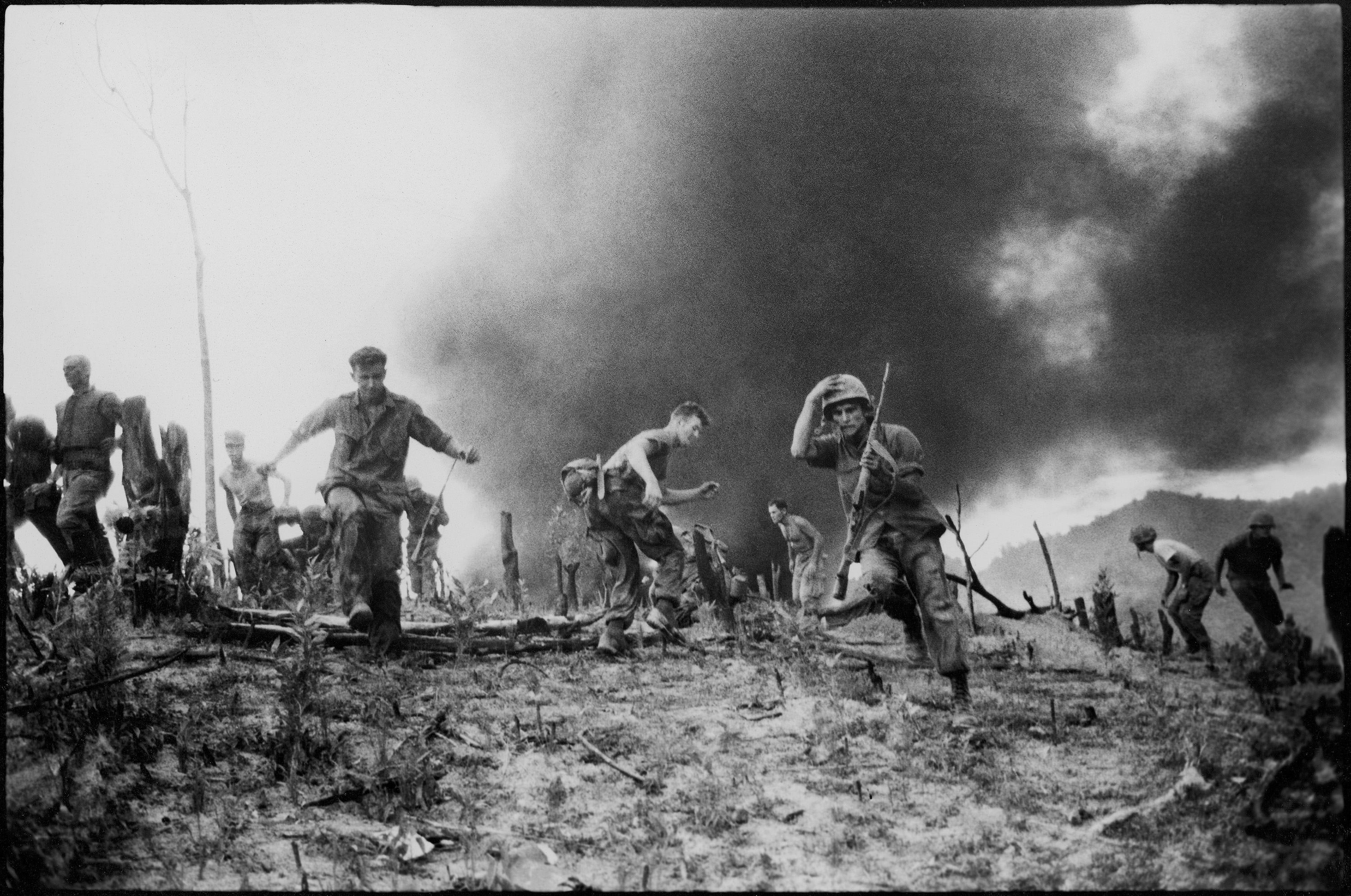 US Marines scatter as a CH-46 helicopter burns Vietnam, July, 1966.jpg