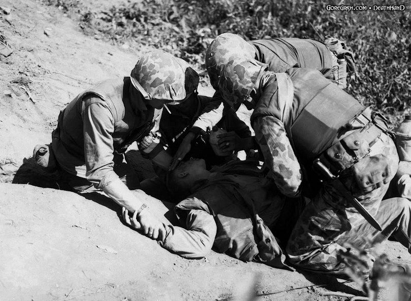wounded-us-marine-getting-water-Korea-nov1952.jpg