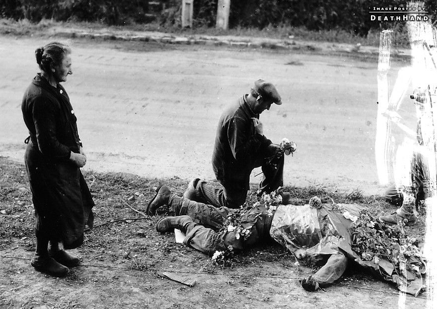 ww2-civs-flowers-on-dead-us-soldier1-Carentan-France-june1945.jpg