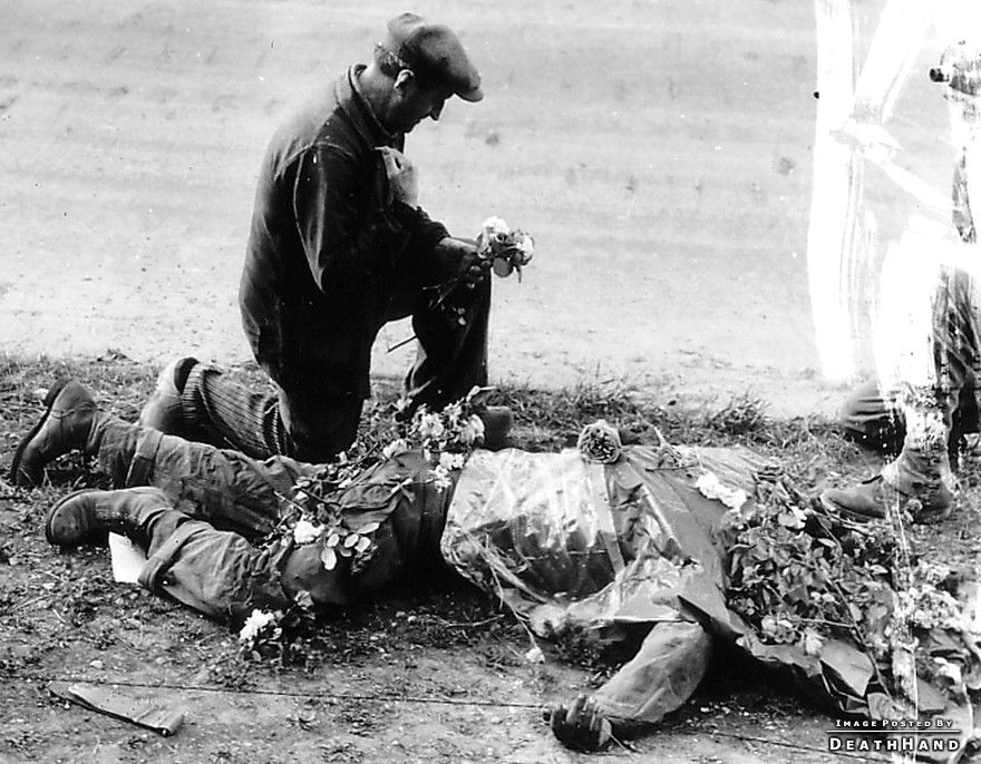 ww2-civs-flowers-on-dead-us-soldier2-Carentan-France-june1945.jpg
