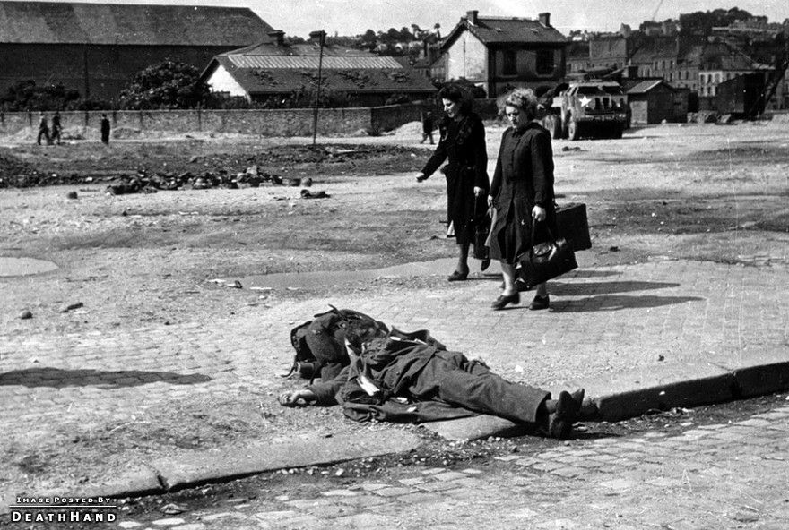 ww2-civs-walk-past-dead-german-soldier-Cherbourg-France-1944.jpg