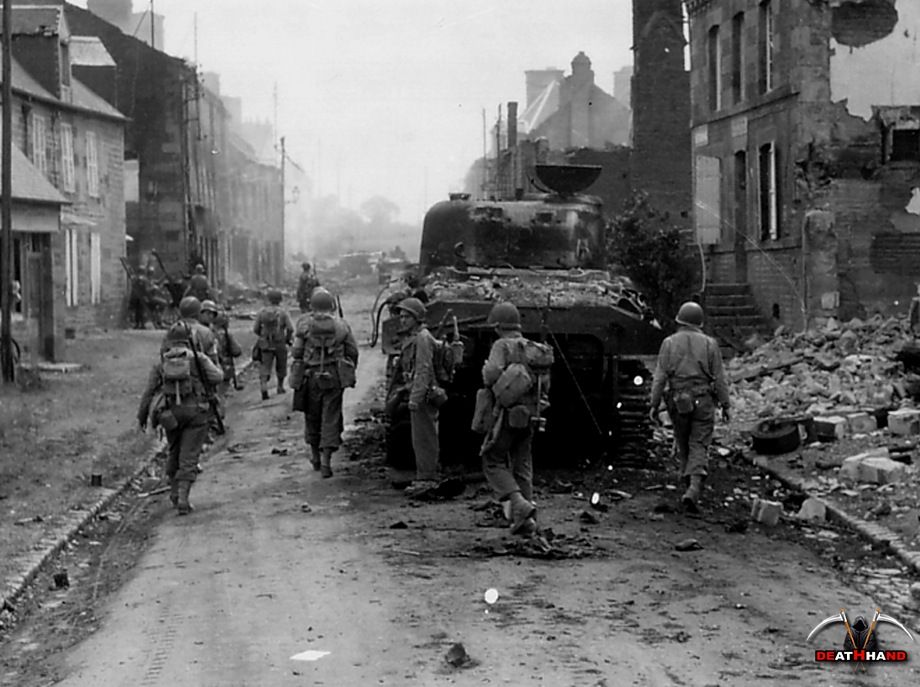 ww2-us-soldiers-pass-burned-out-sherman-tank-France.jpg