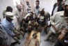177360-the-body-of-slain-libyan-leader-muammar-gaddafi-is-seen-inside-a-stora.jpg