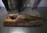 177361-the-body-of-slain-libyan-leader-muammar-gaddafi-is-seen-inside-a-stora.jpg